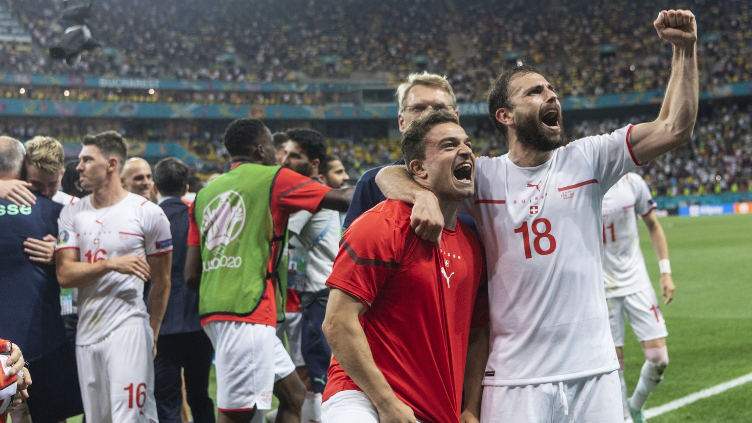 The Swiss team, with from right, Admir Mehmedi and Xherdan Shaqiri, celebrates after winning the Euro 2020 soccer tournament round of 16 match between France and Switzerland at the National Arena stad ...