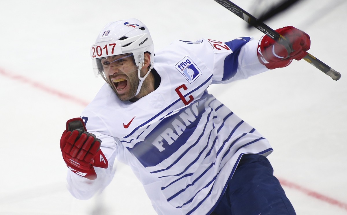 France's Laurent Meunier celebrates after scoring a goal against Italy during the Group A preliminary round match at the Ice Hockey World Championship in Minsk, Belarus, Sunday, May 11, 2014. (AP ...