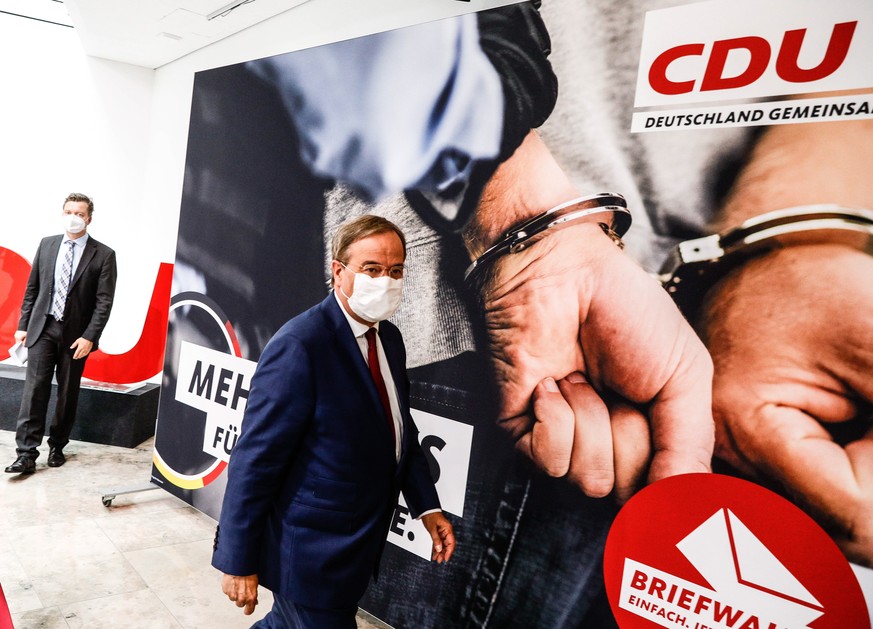 epa09459446 Armin Laschet, top candidate of the Christian Democratic Union (CDU) party, leaves a press conference where the CDU presented their &#039;Agenda for a Safe Germany&#039; campaign in Berlin ...