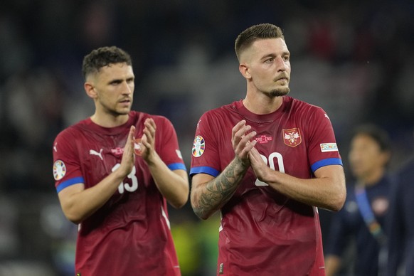 Serbia's Sergej Milinkovic-Savic and Milos Veljkovic applaud fans during a Group C match between Serbia and England at the Euro 2024 soccer tournament in Gelsenkirchen, Germany, Sunday, June 16, ...