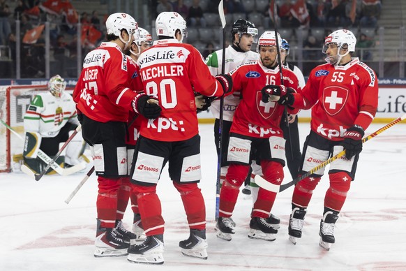 Switzerland's Nicolas Baechler (2-L), celebrates with his teammates Ken Jaeger, David Aebischer and Romain Loeffel, from left, after scoring his side's second goal during a friendly ice hock ...