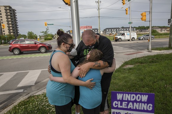 People show up to the location where a family of five was hit by a driver, in London, Ontario, Monday, June 7, 2021. Multiple members of the family died and one is in critical condition. A 20 year old ...