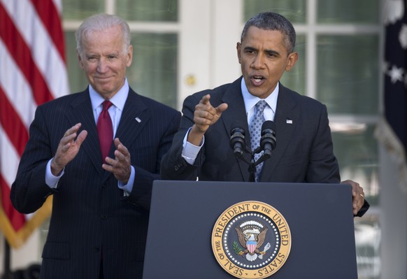 President Barack Obama, with Vice President Joe Biden, gestures as he speaks in the Rose Garden of the White House in Washington, Tuesday, April 1, 2014, about the Affordable Care Act. The deadline to ...