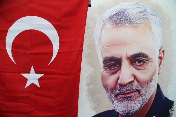 epa08122195 Protesters hold a portrait of slain Iranian Revolutionary Guards Corps (IRGC) Lieutenant general and commander of the Quds Force Qasem Soleimani and a Turkish flag during a demonstration a ...