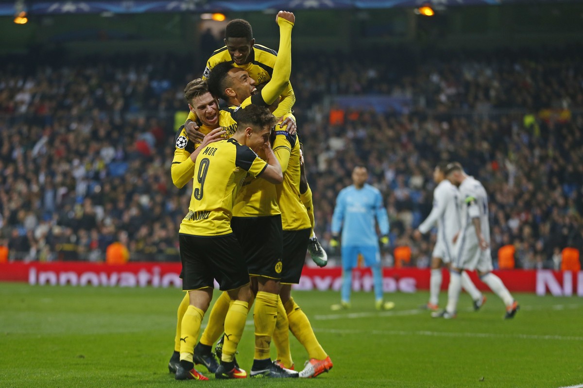 Dortmund players celebrate after Marco Reus scored his side's 2nd goal during the Champions League, Group F, soccer match between Real Madrid and Borrusia Dortmund at the Santiago Bernabeu stadiu ...