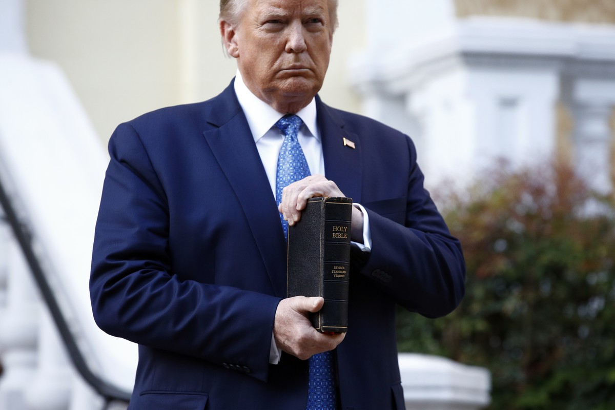 FILE - In this June 1, 2020, file photo, President Donald Trump holds a Bible as he visits outside St. John's Church across Lafayette Park from the White House in Washington. Part of the church w ...