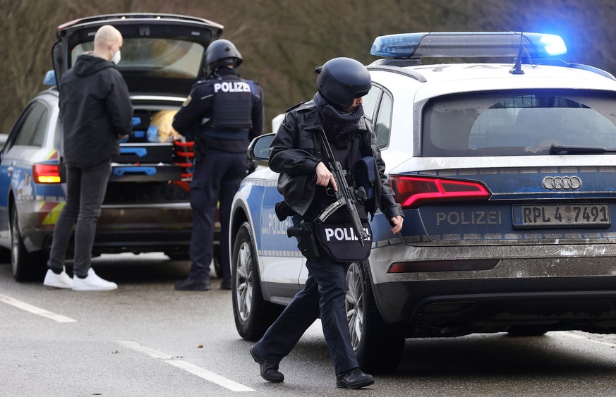 epa09719421 Police officers secure the crime scene in Ulmet, Germany, 31 January 2022. According to the police in Kaiserslautern, two police officers were shot during a routine traffic check in the di ...