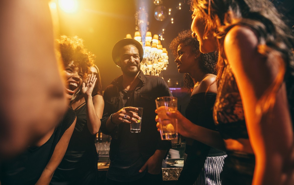 Image group of friends enjoying a party at pub. Happy young people having fun at nightclub.