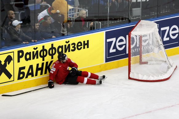 Switzerland&#039;s Luca Cunti lies on the ice, during the 2014 IIHF Ice Hockey World Championships preliminary round game Switzerland vs Belarus, at the Minsk Arena, in Minsk, Belarus, Monday, May 12, ...