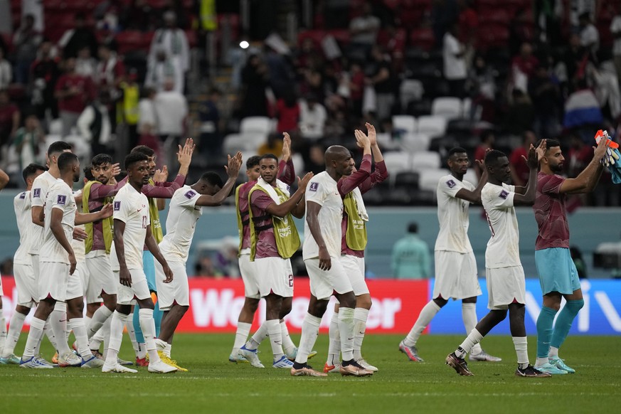 Qatar's players react at the end of the World Cup group A soccer match between the Netherlands and Qatar, at the Al Bayt Stadium in Al Khor, Qatar, Tuesday, Nov. 29, 2022. (AP Photo/Lee Jin-man)