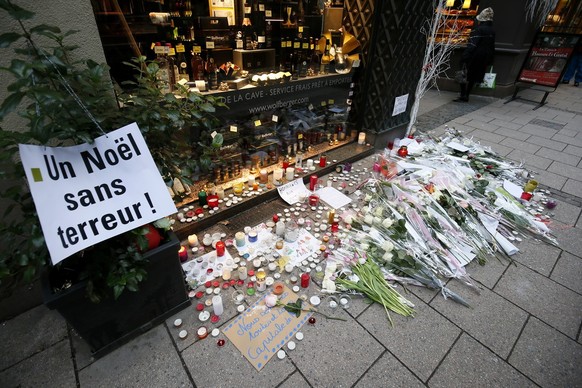 epa07230475 A sign reading A Christmas without terror alongside, candles, letters and flowers at a place close to the Christmas Market, in Strasbourg, France, 14 December 2018, where a terror attack t ...