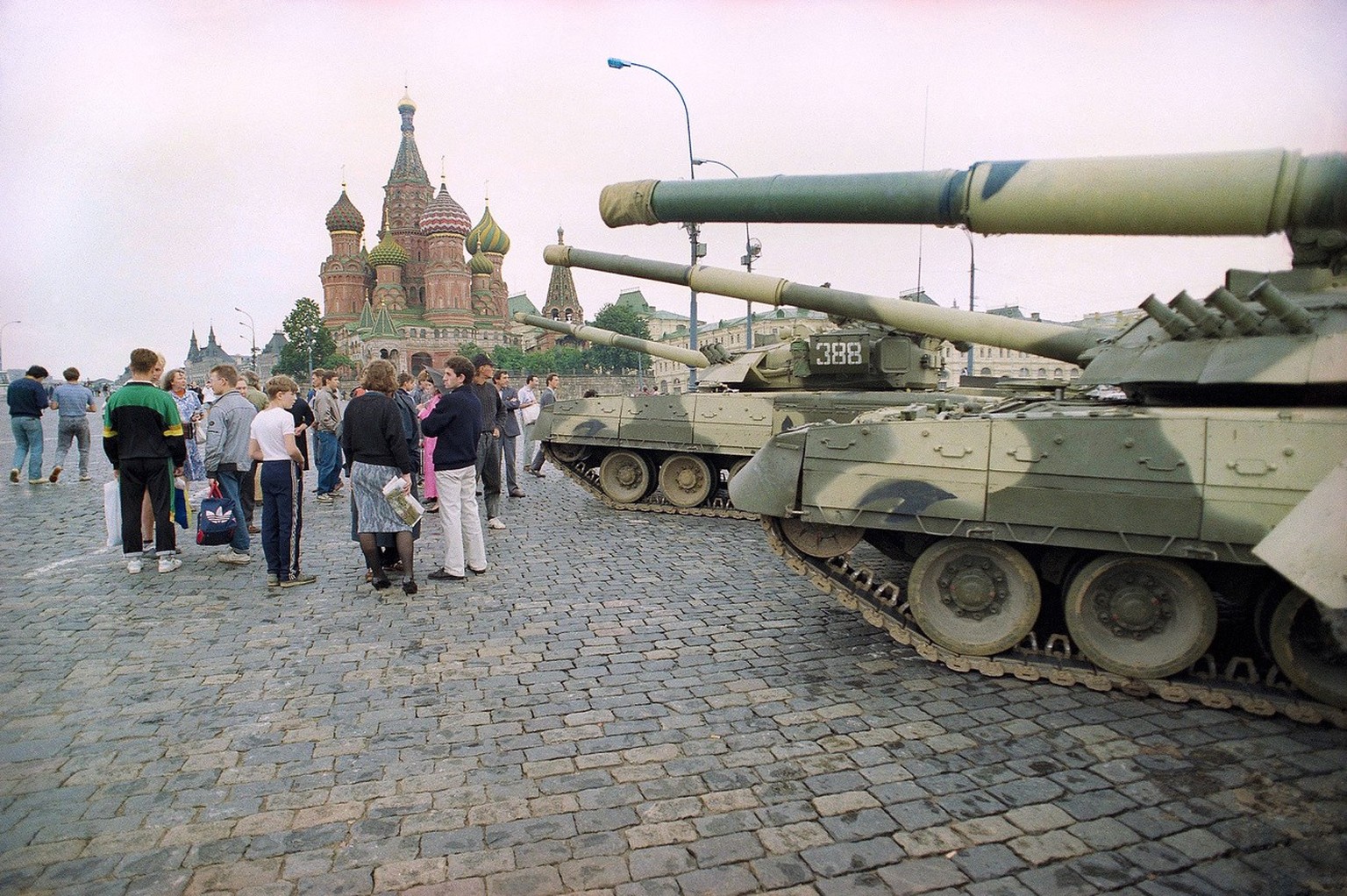 FILE - In this Monday, Aug. 19, 1991 file photo, Groups of people wander among the half dozen Soviet tanks parked behind the Red Square with St. Basil&#039;s Cathedral in the background, near the bank ...