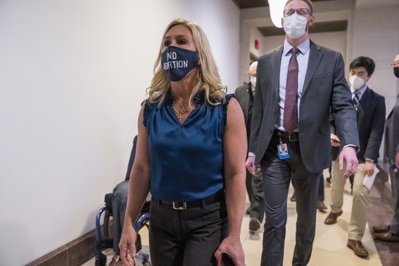 Rep. Marjorie Taylor Greene, R-Ga., walks with fellow House Republicans on Capitol Hill in Washington, Wednesday, Feb. 3, 2021, following a meeting called by House Minority Leader Kevin McCarthy. Demo ...