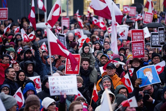 EDS NOTE: OBSCENITY - A crowd walks to the US consulate to protest against Trump's policy towards Greenland in Nuuk, Greenland, Saturday, Jan. 17, 2026. (AP Photo/Evgeniy Maloletka)
Greenland US  ...