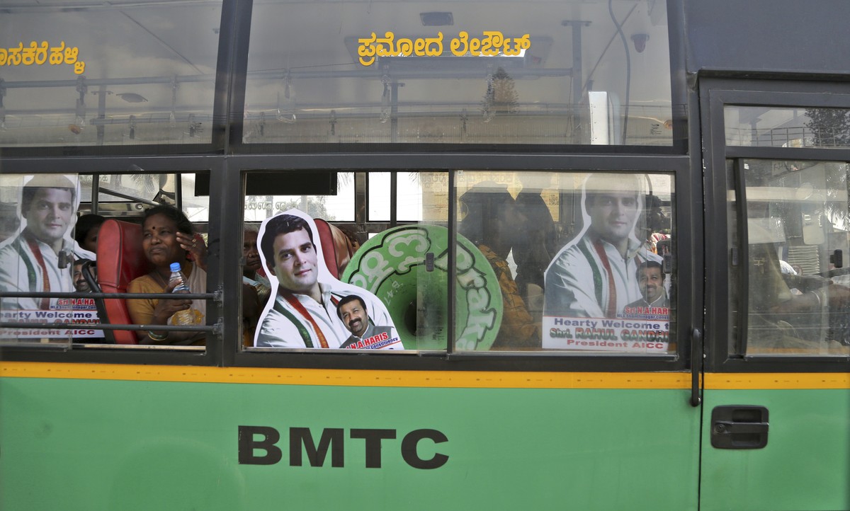 Supporters of India's Congress party President Rahul Gandhi travel in bus with his cutouts to attend an election campaign rally in Bangalore, India, Sunday, March 31, 2019. India's general e ...