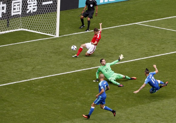 epa05357467 Ben Davies (top) of Wales clears the ball from a shot by Marek Hamsik of Slovakia (R) during the UEFA EURO 2016 group B preliminary round match between Wales and Slovakia at Stade de Borde ...