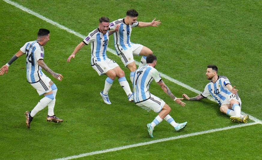 Argentina&#039;s Lionel Messi, right on the pitch, celebrates after scoring his side&#039;s first goal on a penalty kick during the World Cup final soccer match between Argentina and France at the Lus ...