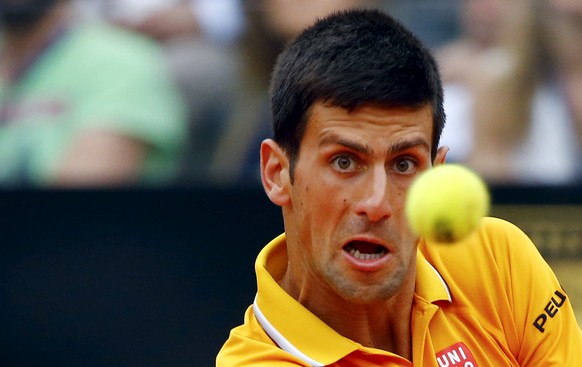 Novak Djokovic of Serbia returns the ball to Kei Nishikori of Japan during their match at the Rome Open tennis tournament in Rome, Italy, May 15, 2015. REUTERS/Stefano Rellandini