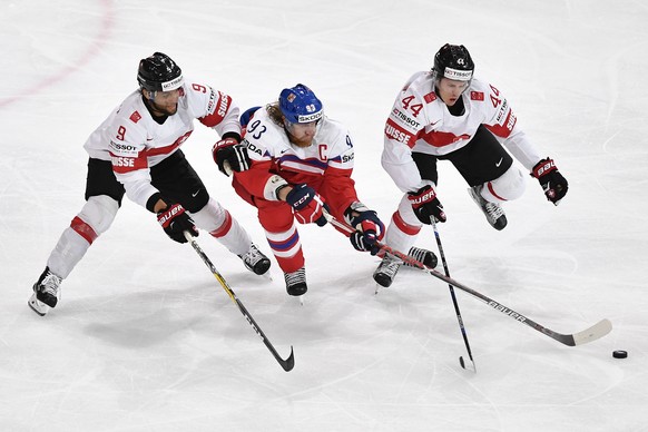 Switzerlandâs Thomas Ruefenacht, left, and Switzerlandâs Pius Suter, right, in action against Czech Republicâs Jakub Voracek during their Ice Hockey World Championship group B preliminary round  ...