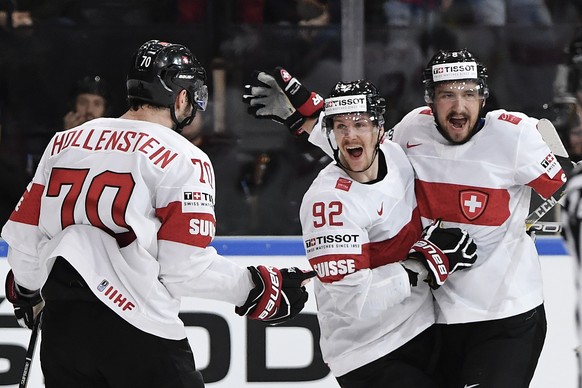 Switzerlandâs Denis Hollenstein, Gaetan Haas and Vincent Praplan, from left, celebrate their first goal during their Ice Hockey World Championship group B preliminary round match between Switzerland ...