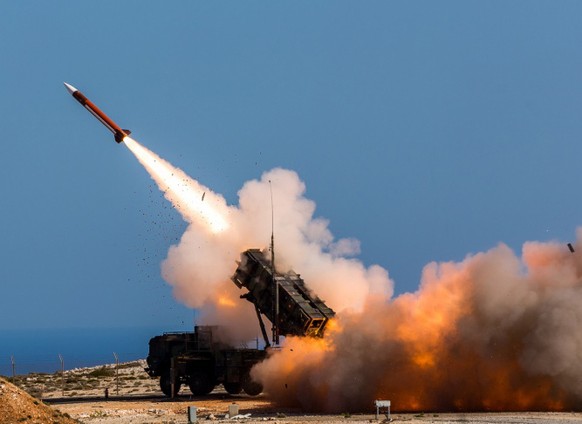 FILE - In this image released by the U.S. Department of Defense, German soldiers assigned to Surface Air and Missile Defense Wing 1, fire the Patriot weapons system at the NATO Missile Firing Installa ...