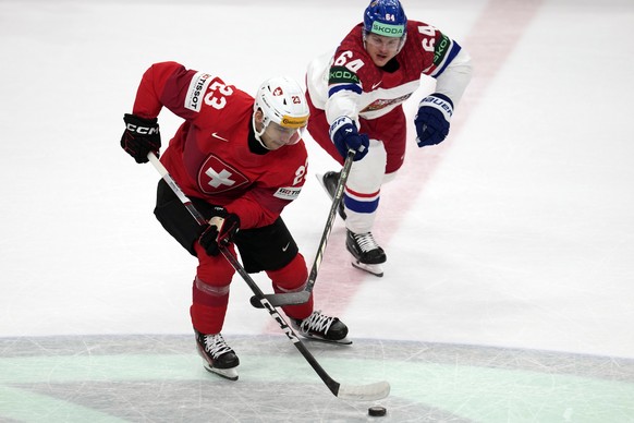 Switzerland&#039;s Philipp Kurashev, left, takes the puck as Czech Republic&#039;s David Kampf reaches in during the gold medal match between Czech Republic and Switzerland at the Ice Hockey World Cha ...