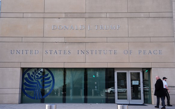 FILE - President Donald Trump's name is seen on the U.S. Institute of Peace building, Dec. 4, 2025, in Washington. (AP Photo/Evan Vucci, File)
Trump DOGE Aftershocks