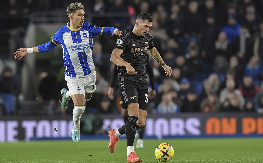 epa10384344 Granit Xhaka of Arsenal and Jeremy Sarmiento of Brighton &amp; Hove Albion battle for the ball during the English Premier League soccer match between Brighton &amp; Hove Albion FC and Arse ...