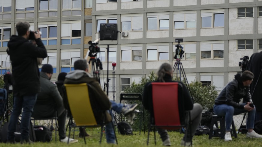 Members of the media waits outside the Agostino Gemelli hospital under the rooms on the top floor normally used when a pope is hospitalised, in Rome, Thursday, March 30, 2023, after The Vatican said P ...