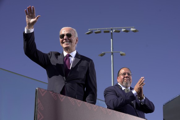 President Joe Biden, left, joined by Stephen Roe Lewis, Governor of the Gila River Indian Community, arrives to speak at the Gila Crossing Community School in the Gila River Indian Community reservati ...