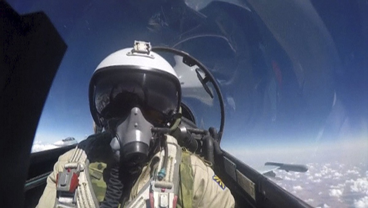 A frame grab taken from footage released by Russia's Defence Ministry October 22, 2015, shows a pilot of the Russian air force inside the cabin of a military jet during a sortie at an unknown loc ...