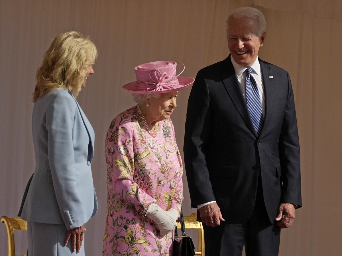 FILE - In this June 13, 2021 file photo US President Joe Biden and First Lady Jill Biden smile while standing with Britain's Queen Elizabeth II watching a Guard of Honour march past before their  ...