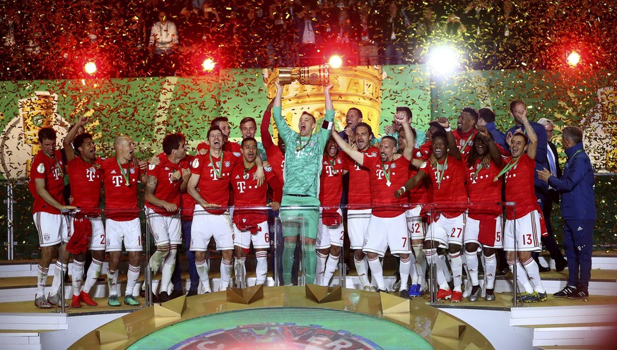 Bayern players celebrate with the trophy after winning the German soccer cup, DFB Pokal, final match between RB Leipzig and Bayern Munich at the Olympic stadium in Berlin, Germany, Saturday, May 25, 2 ...