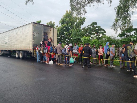 epa09517603 A handout photo made available by the National Police that shows the security forces as they rescue 126 migrants from Haiti, Nepal and Ghana who were abandoned by alleged traffickers insid ...