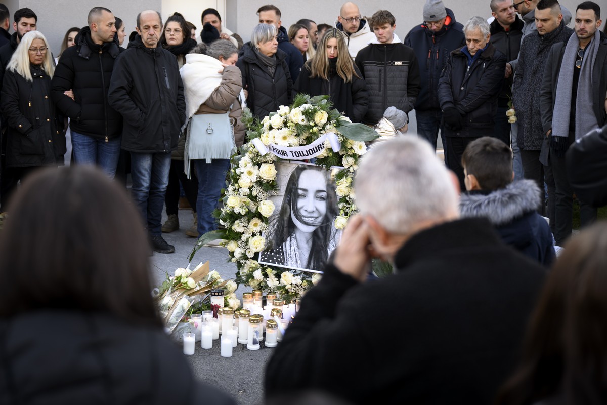 People lay flowers in front of the home of one of the victims after a "Marche Blanche" (White March) to pay tribute for the victims of the 11 December shooting, in Sion, Switzerland, Saturda ...