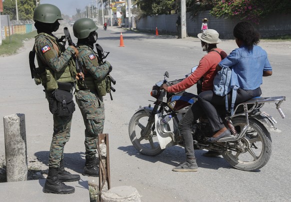 Soldiers patrol the road near the international airport in Port-au-Prince, Haiti, Wednesday, March 13, 2024. (AP Photo/Odelyn Joseph)