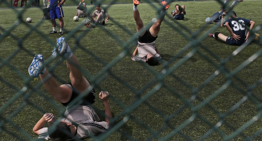 Young soccer players stretch during a practice at Pyongyang International Football School in Pyongyang, North Korea, Wednesday, Aug. 24, 2016. North Korea has poured funds into the development and tra ...