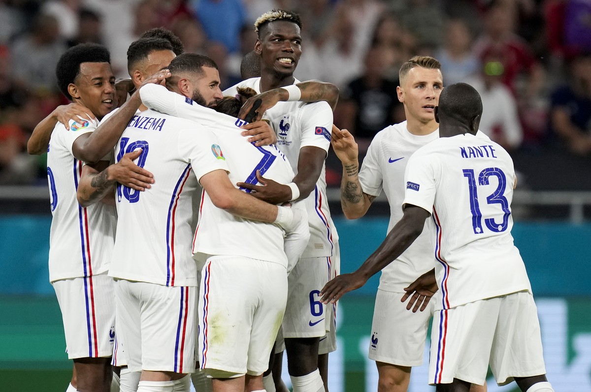 France's Karim Benzema, third left, is congratulated by teammates after scoring his team's second goal during the Euro 2020 soccer championship group F match between Portugal and France at t ...