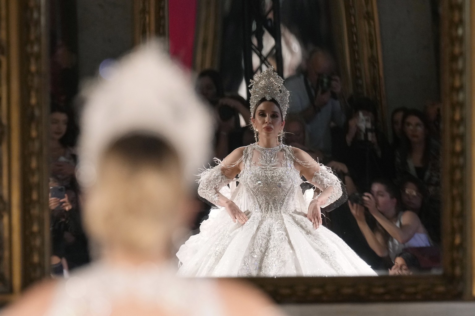Emma Coronel, the wife of Mexican narco Joaquin Guzman, alias El Chapo, is reflected in a mirror wearing a creation from the April Black Diamond Spring Summer 2025 collection in Milan, Italy, Sunday,  ...