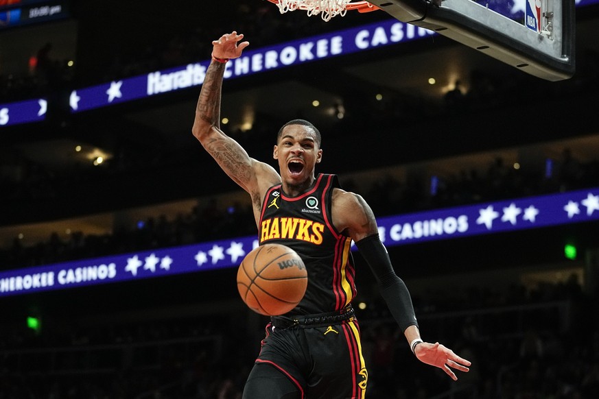 Atlanta Hawks guard Dejounte Murray reacts after scoring a basket against the Cleveland Cavaliers during the first half of an NBA basketball game Friday, Feb. 24, 2023, in Atlanta. (AP Photo/John Baze ...