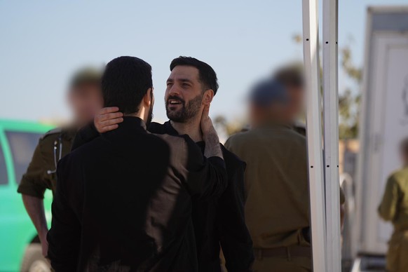 epa12449973 A handout photo made available by the Israeli Government Press Office shows Gali (R) and Ziv Berman at the Israeli military base of Re&#039;im, Israel, 13 October 2025, following their rel ...