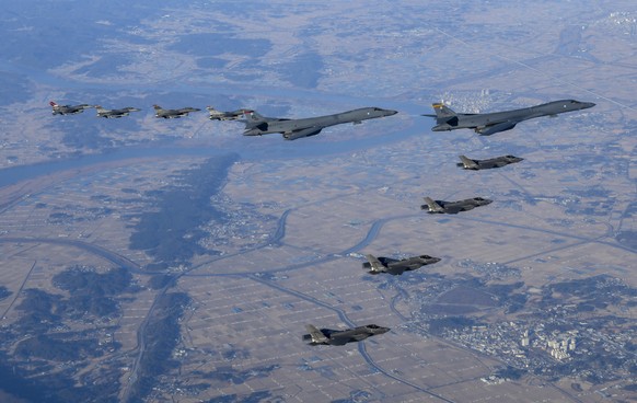 In this photo provided by South Korean Defense Ministry, two U.S. Air Force B-1B bombers, top center, four South Korean Air Force F-35 fighter jets and four US Air Force F-16 fighter jets fly over Sou ...