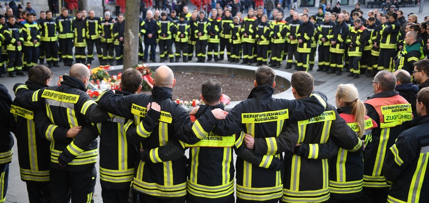 dpatopbilder - 08.12.2019, Bayern, Augsburg: Am Königsplatz trauern Feuerwehrmänner. Ein Feuerwehrmann war am Abend des 06.12.2019 in seiner Freizeit hier in einer Auseinandersetzung mit einer Gruppe  ...