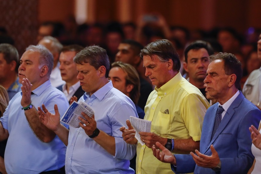 Brazil's president Jair Bolsonaro, second right, who running for reelection, and Sao Paulo candidate for governor Tarcisio de Freitas, center left, attend a Mass at the National Sanctuary of Our Lady  ...