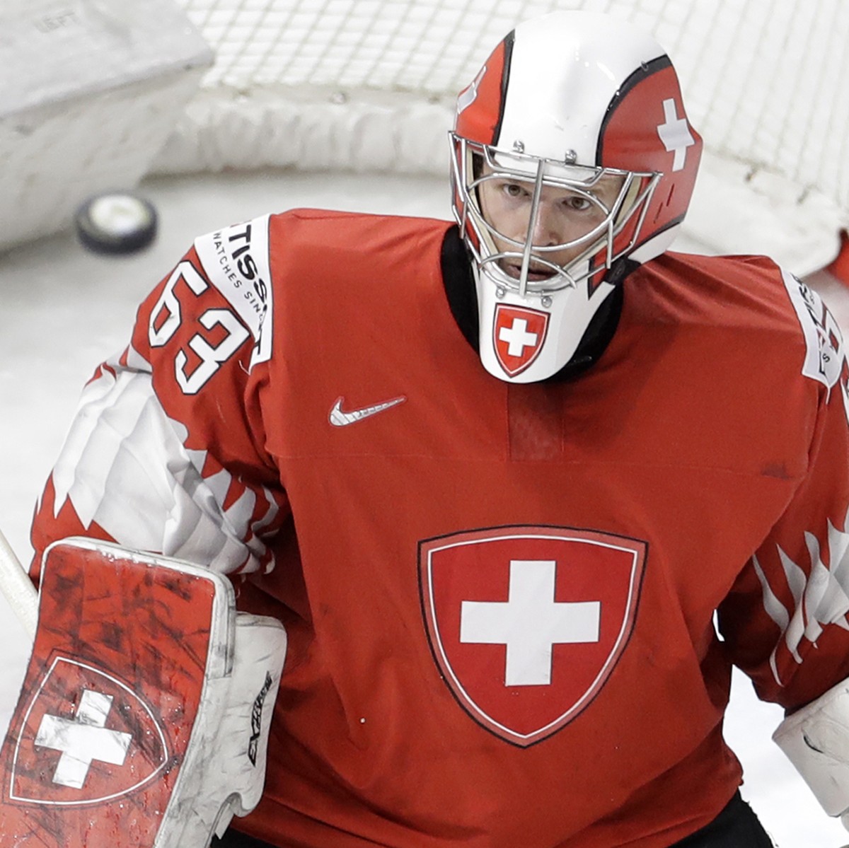 Switzerland's goalie Leonardo Genoni looks the puck during the Ice Hockey World Championships final match between Sweden and Switzerland at the Royal arena in Copenhagen, Denmark, Sunday, May 20, ...