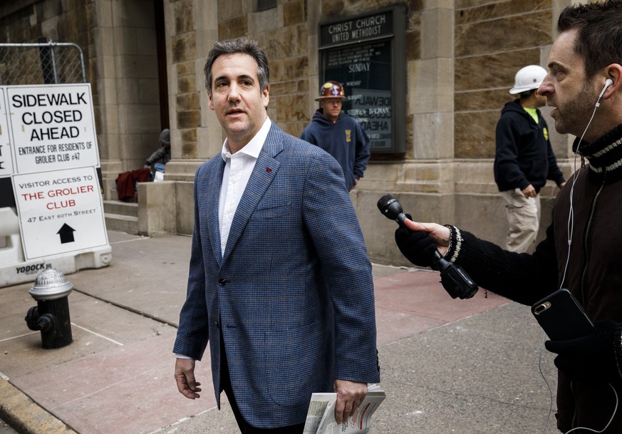 epa06664209 Attorney Michael Cohen (C), US President Donald J. Trump&#039;s long-time personal attorney, walks from his hotel to his apartment while a television crew tries to talk to him in New York, ...