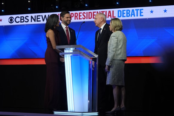 Republican vice presidential nominee Sen. JD Vance, R-Ohio, and his wife Usha Vance talk with Democratic vice presidential candidate Minnesota Gov. Tim Walz and his wife Gwen Walz after the vice presi ...