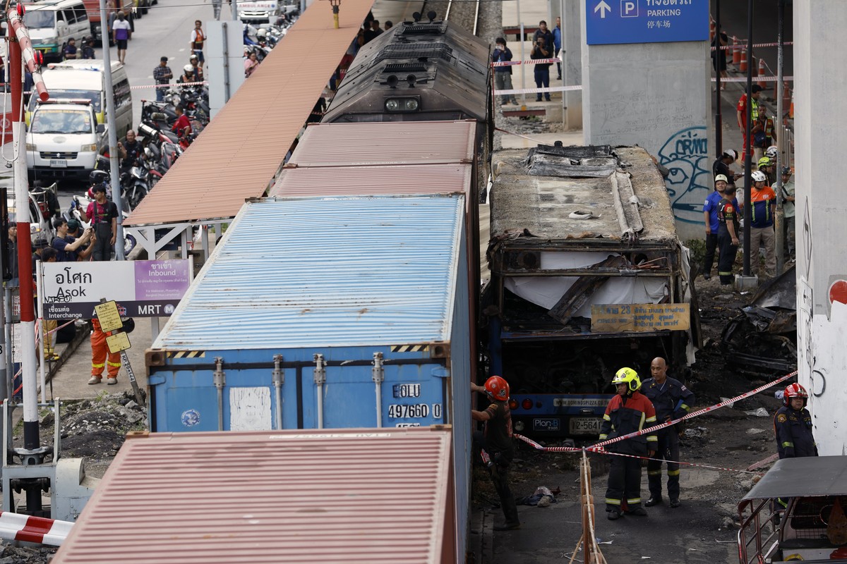 epa12962493 Thai rescue workers work on the wreckage of a public bus after it collided with a freight train at the Airport Rail Link's Makkasan station in Bangkok, Thailand, 16 May 2026. A freigh ...