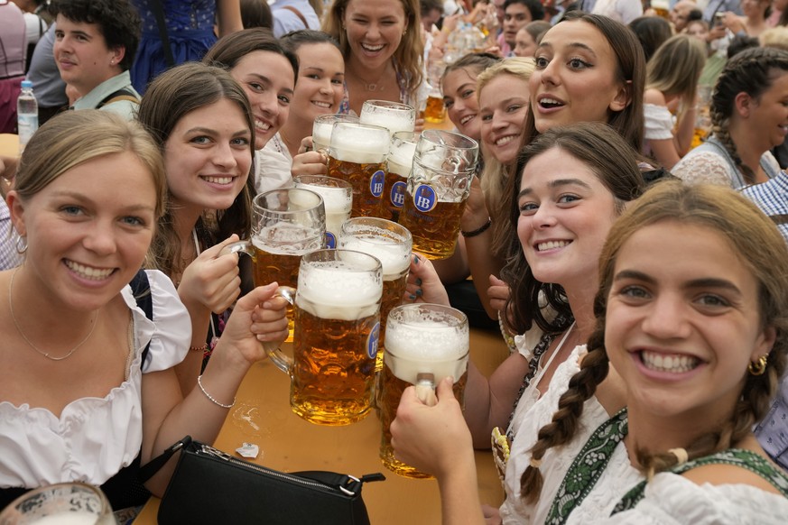 FILE - Women with glasses of beer pose for a photo on day one of the 188th &#039;Oktoberfest&#039; beer festival in Munich, Germany, Saturday, Sept. 16, 2023. The southern German state of Bavaria will ...