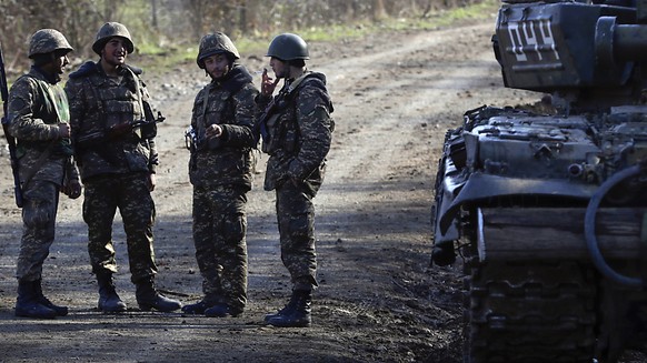 Ethnic Armenian soldiers stand at a checkpoint on a road